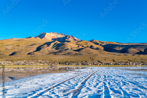 View of the dormant volcano Tunupa and the village of Coqueza at the Uyuni Salt Flat photo