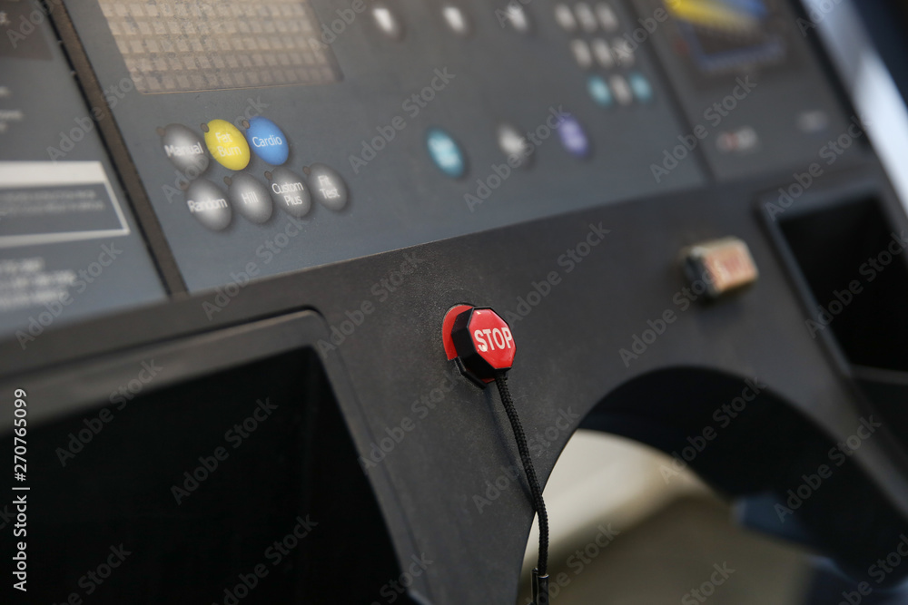 Fototapeta premium stop button on the treadmill. the control panel of the treadmill in the gym. red stop button