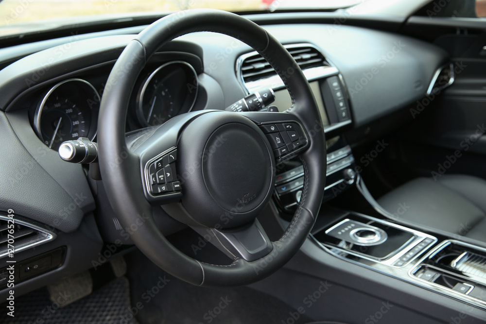 steering wheel of a modern car close-up. the front part of the cabin in a premium car