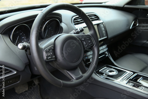 steering wheel of a modern car close-up. the front part of the cabin in a premium car