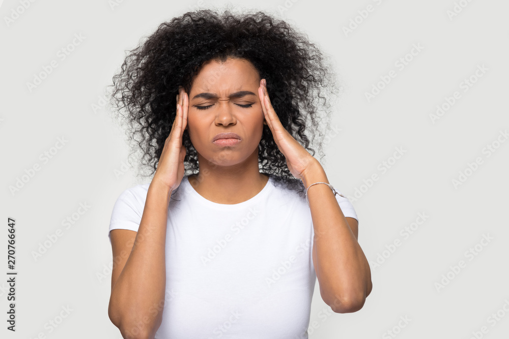 Headshot portrait stressed woman touching temples suffering from headache Headshot portrait stressed woman touching temples suffering from headache