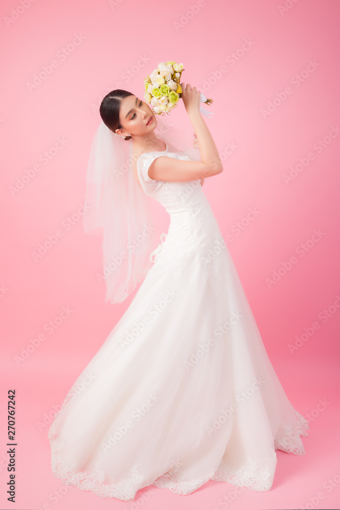 Fototapeta premium Beautiful asian bride portrait in pink studio