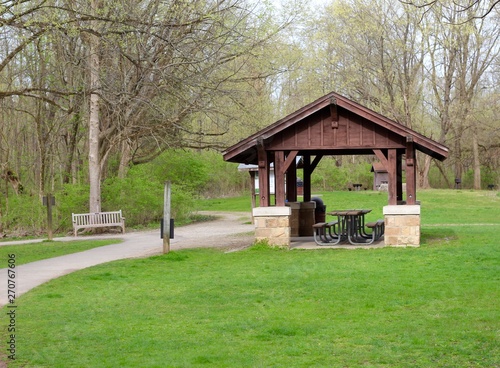 The picnic shelter in the woods of the park.