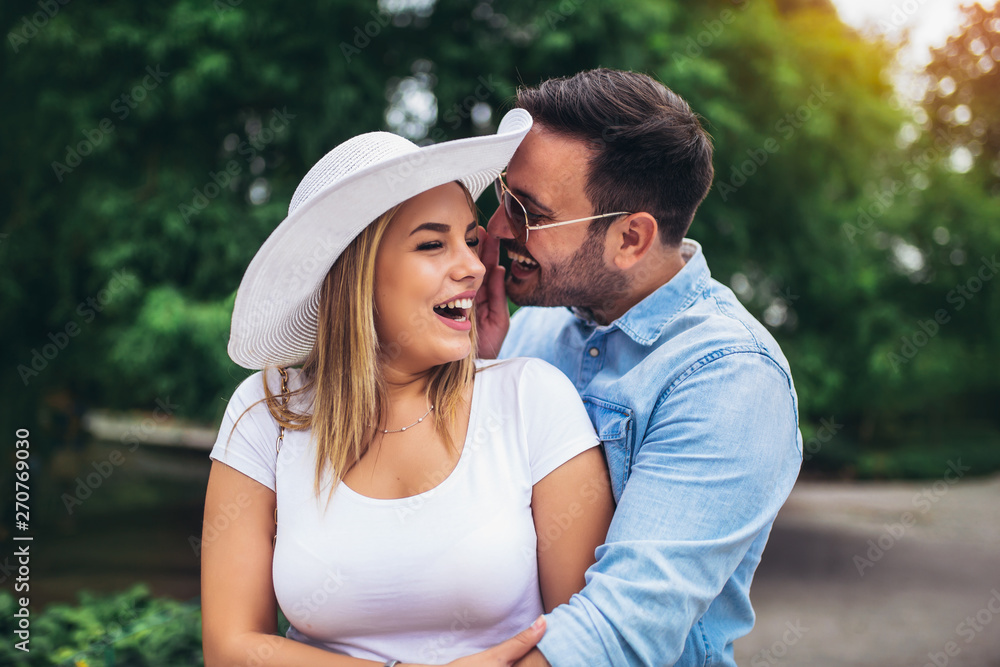 Fototapeta premium Happy young couple having fun outdoors and smiling.