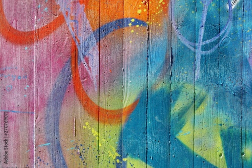 Multicolored abstract graffiti detail on a concrete wall.