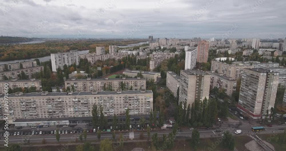 Aerial view of buildings near the river Dnieper, left bank, Kiev - Ukraine. Cloudy day, illuminated day in the autumn. Wide shot. Architecture of the USSR. 4K shot with drone. Aerial view of buildings near the river Dnieper, left bank, Kiev - Ukraine. Cloudy day, illuminated day in the autumn. Wide shot. Architecture of the USSR. 4K shot with drone.