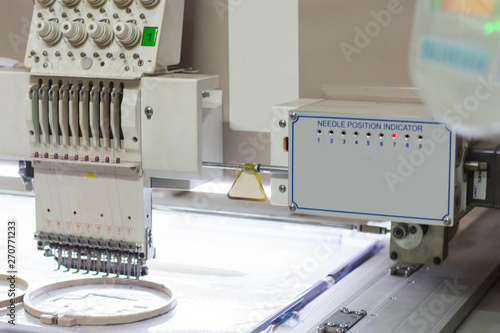 close up of white embroidery machine in stanby mode photo