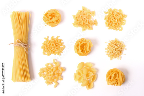 Different types of pasta on a white background top view.