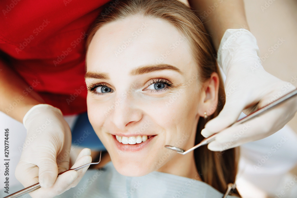 Dentist examining a patient's teeth in the dentist. Dentist examining a patient's teeth in the dentist.