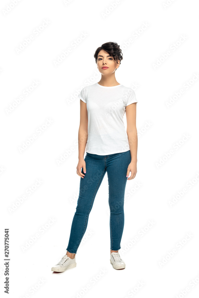 attractive latin brunette woman standing in blue jeans and white t-shirt isolated on white attractive latin brunette woman standing in blue jeans and white t-shirt isolated on white