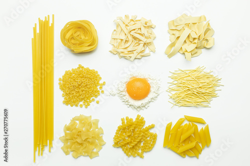 Collection of italian pasta, flour and chicken egg isolated top view on white background.
