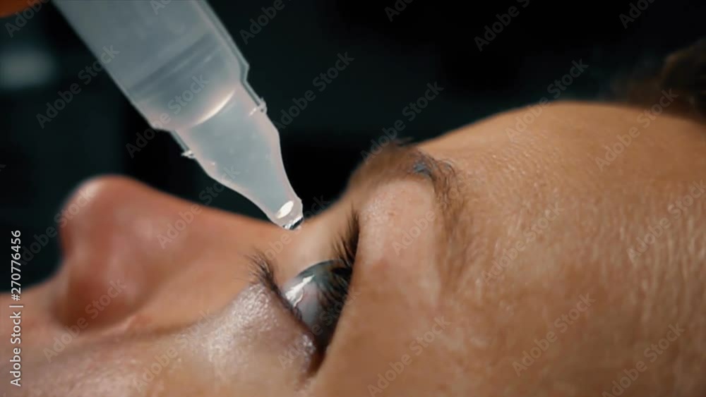Close up of beautiful woman pouring eye drops, slow motion Close up of beautiful woman pouring eye drops, slow motion