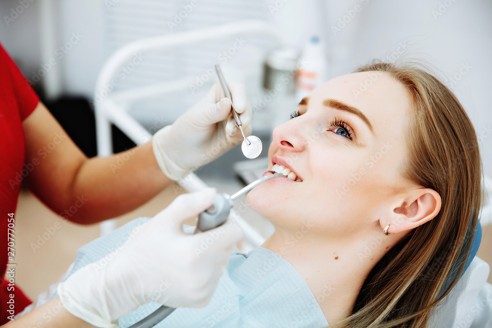 Dentist examining a patient's teeth in the dentist. Dentist examining a patient's teeth in the dentist.
