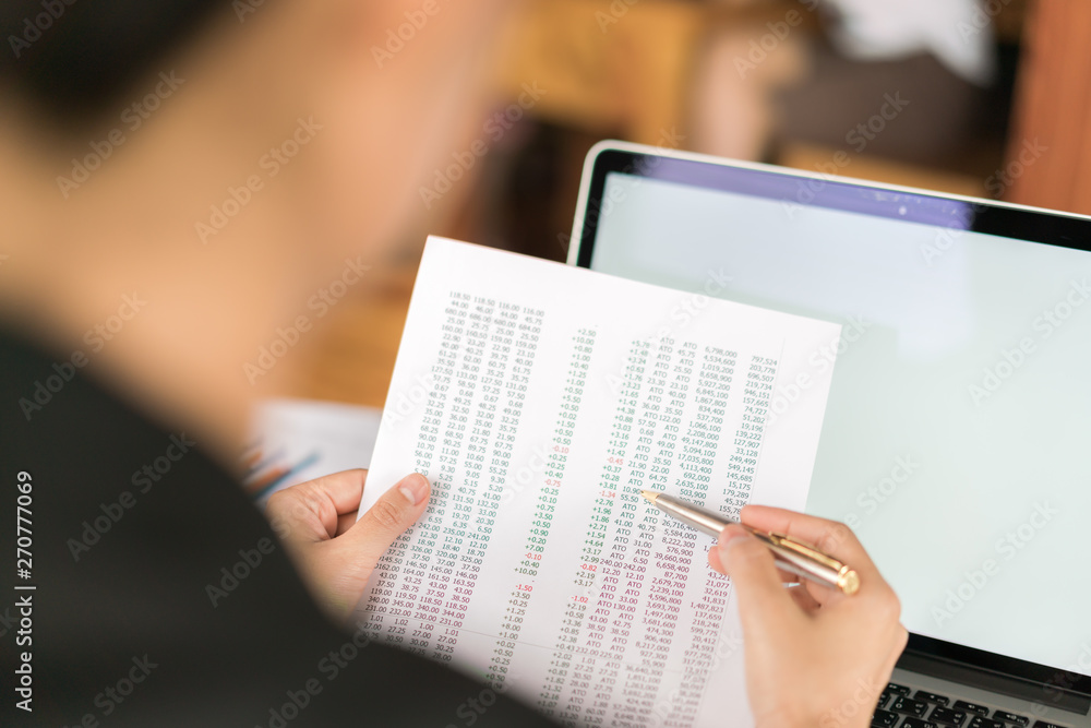 Business woman hand with Financial charts and laptop on the table . Business woman hand with Financial charts and laptop on the table .