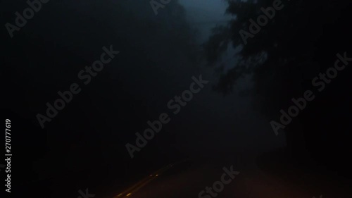 Driving Car in Dense Fog in the Evening. Bad Weather Condition with Zero Visability. Perspective View from Cabin photo