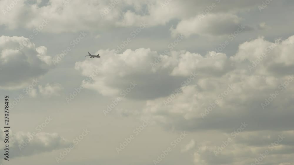 Big government airplane is crossing the sky with clouds and moving to landing Big government airplane is crossing the sky with clouds and moving to landing