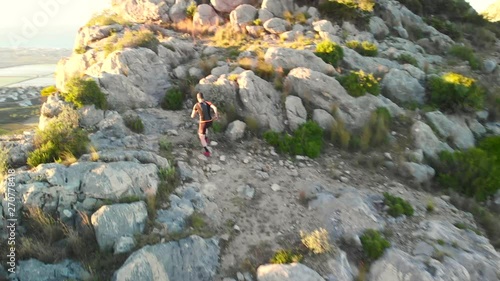 Aerial drone view of a trail runner on the top of Segaria mountain, in Spain. photo