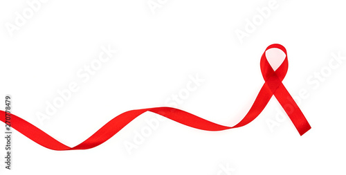 Fotografie Aids Awareness Red heart Ribbon isolated on white background .