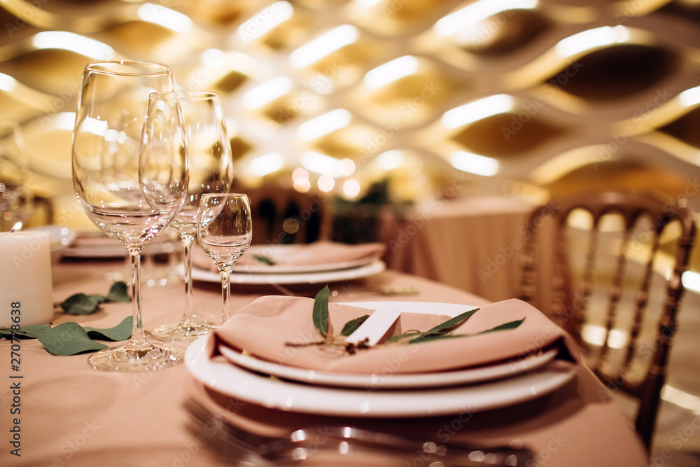 Table setting for a wedding ceremony at swimming pool. round table with white tablecloth Table setting for a wedding ceremony at swimming pool. round table with white tablecloth