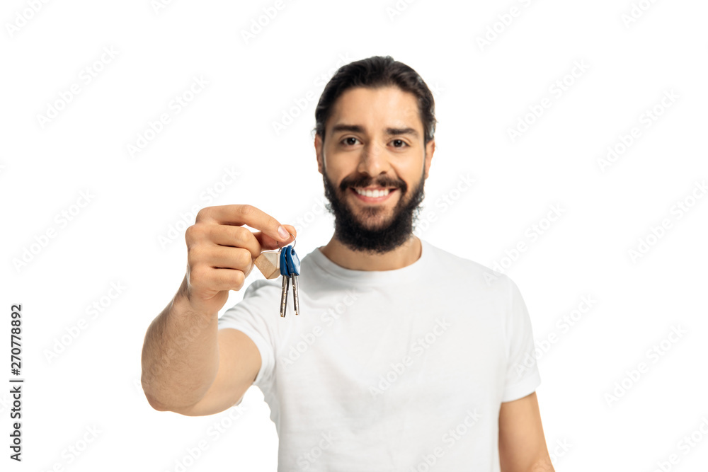 bearded latin man holding key and smiling isolated on white bearded latin man holding key and smiling isolated on white