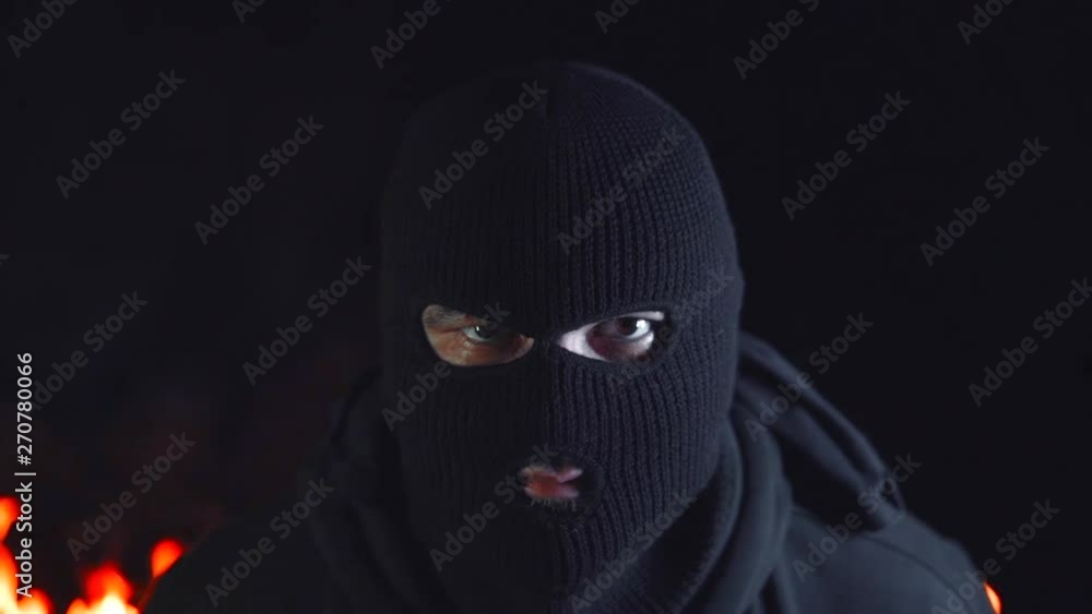 Portrait of protesting activist in mask against burning barricades at night. Concept of strikes, political conflicts and confrontation. Portrait of protesting activist in mask against burning barricades at night. Concept of strikes, political conflicts and confrontation.