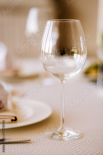 Table setting for a wedding ceremony at swimming pool. round table with white tablecloth