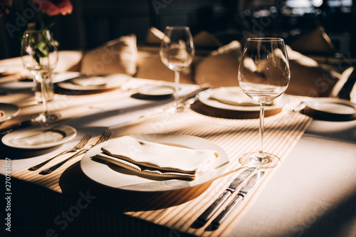 Table setting for a wedding ceremony at swimming pool. round table with white tablecloth
