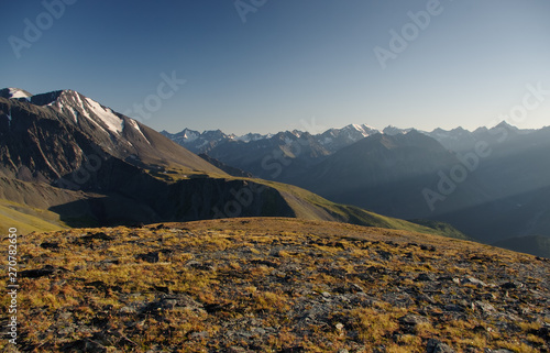 Mountain stone rocky slope on the background of high snow glacier ranges