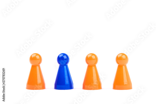A series of orange game pieces and one different and exceptional blue figure as leader or boss, isolated on a white background