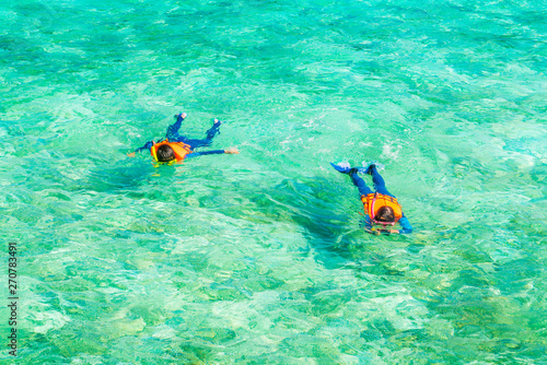 Couple snorkeling in tropical Maldives island .