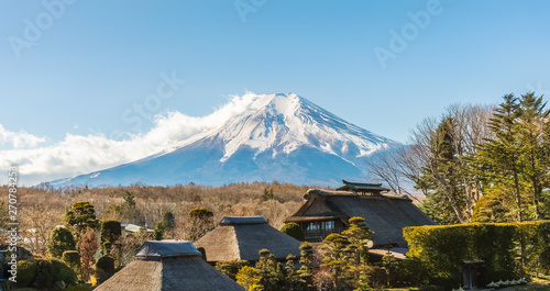 Japanese traditional house at Oshino Hakkai village with Mount Fuji in background. photo