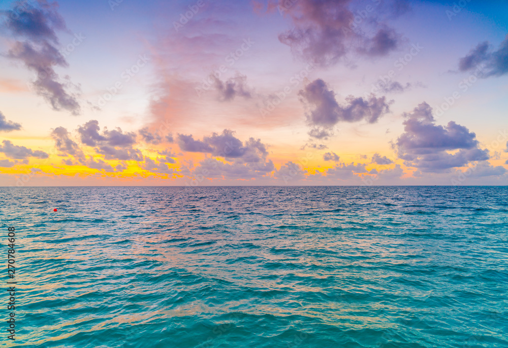 Beautiful sunset with sky over calm sea  in tropical Maldives island .
