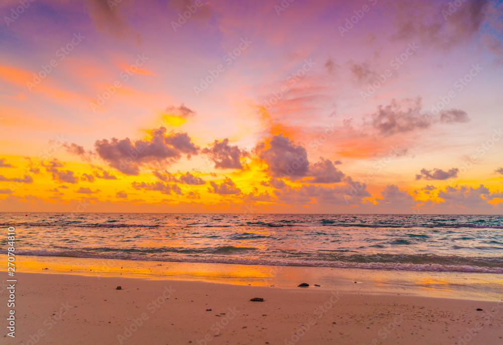 Beautiful sunset with sky over calm sea  in tropical Maldives island .