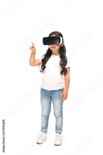 latin child pointing with finger while wearing virtual reality headset isolated on white © LIGHTFIELD STUDIOS