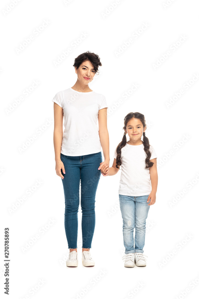 happy latin mother holding hands with cute daughter isolated on white happy latin mother holding hands with cute daughter isolated on white