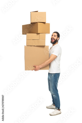 cheerful latin man holding carton boxes and smiling isolated on white