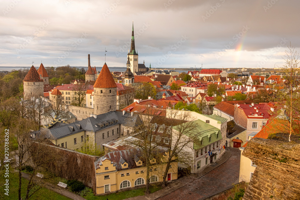 Fototapeta premium Panorama of the city center of Tallinn, with a rainbow in the sky on a spring evening after a thunderstorm and rain