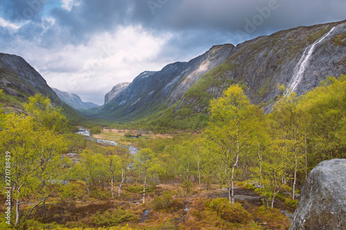 dramatic landscape of Manafossen Falls and the valley of the river  Man in in the province of Rogaland Norway in the spring in cloudy weather with clearances photo