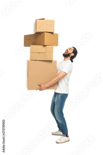 happy bearded latin man holding carton boxes and smiling isolated on white