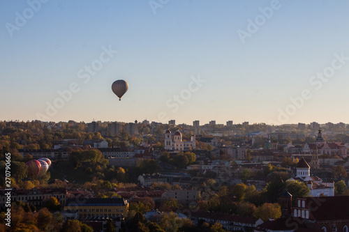 Flight of balloons over the Old Town of Vilnius at sunset. Lithuania