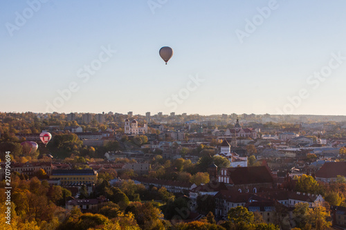 Flight of balloons over the Old Town of Vilnius at sunset. Lithuania