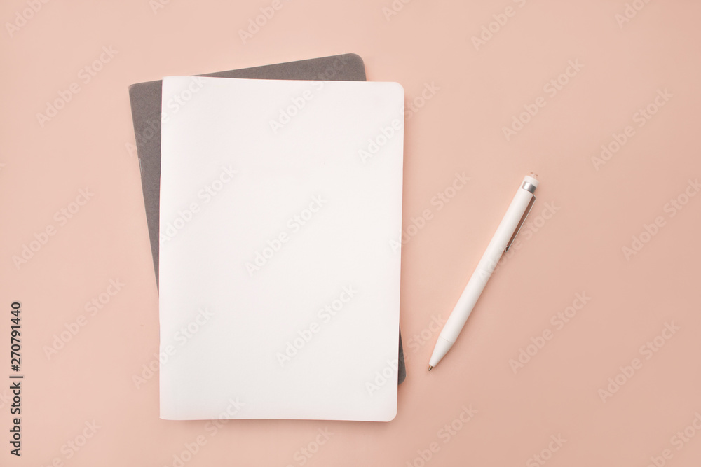 white lies notebook the gray notebook in the form on a coral pink background with white handle lying next closeup - obrazy, fototapety, plakaty 