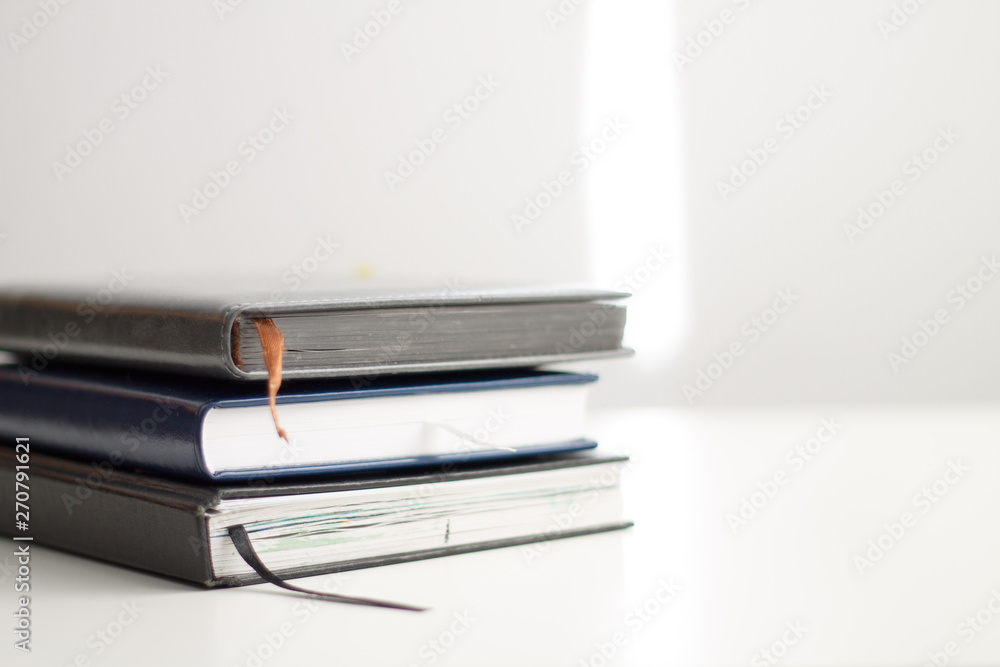 books in a pile on top of each other lie on a white background close-up books in a pile on top of each other lie on a white background close-up