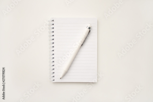 white pad with spring leaves in line on white background white pen is on paper