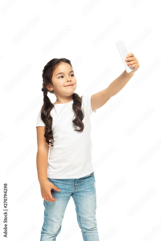happy latin kid taking selfie on smartphone isolated on white happy latin kid taking selfie on smartphone isolated on white