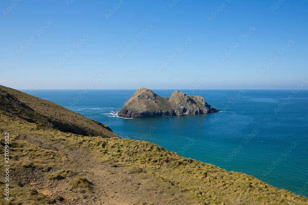 Gull Rock Holywell Bay North Cornwall on a beautiful day with blue sea and sky