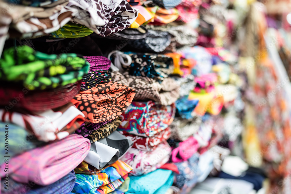 background of colorful fabric stacks