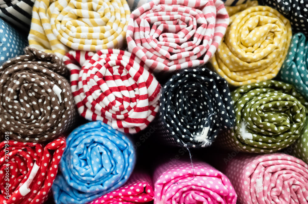 background of colorful fabric stacks background of colorful fabric stacks