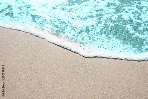 Fototapeta Naklejka Na Ścianę i Meble -  Soft wave of turquoise sea water on the sandy beach.