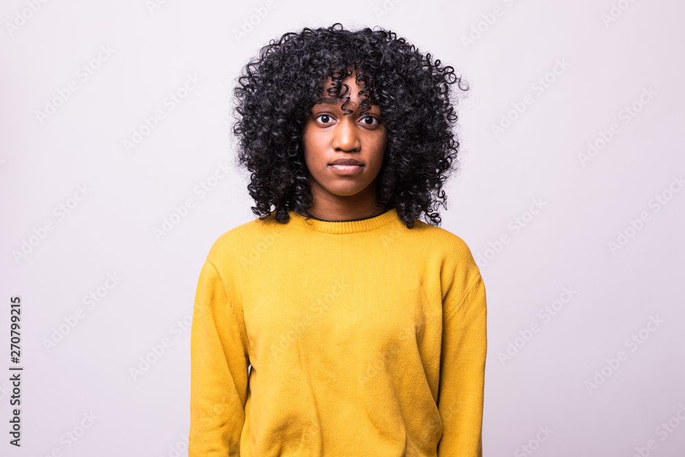 Beautiful african american girl with an afro hairstyle smiling isolated on white background Beautiful african american girl with an afro hairstyle smiling isolated on white background